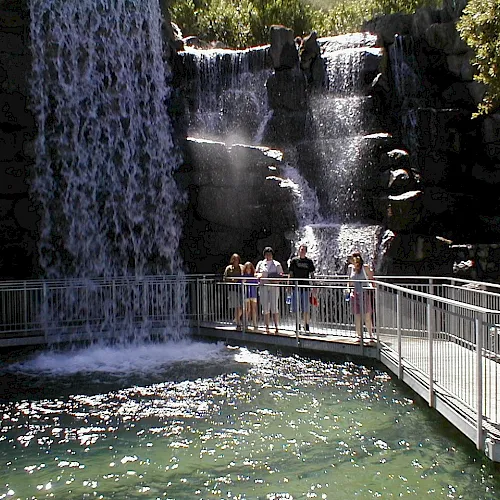 A waterfall and boardwalk at Gilroy Gardens
